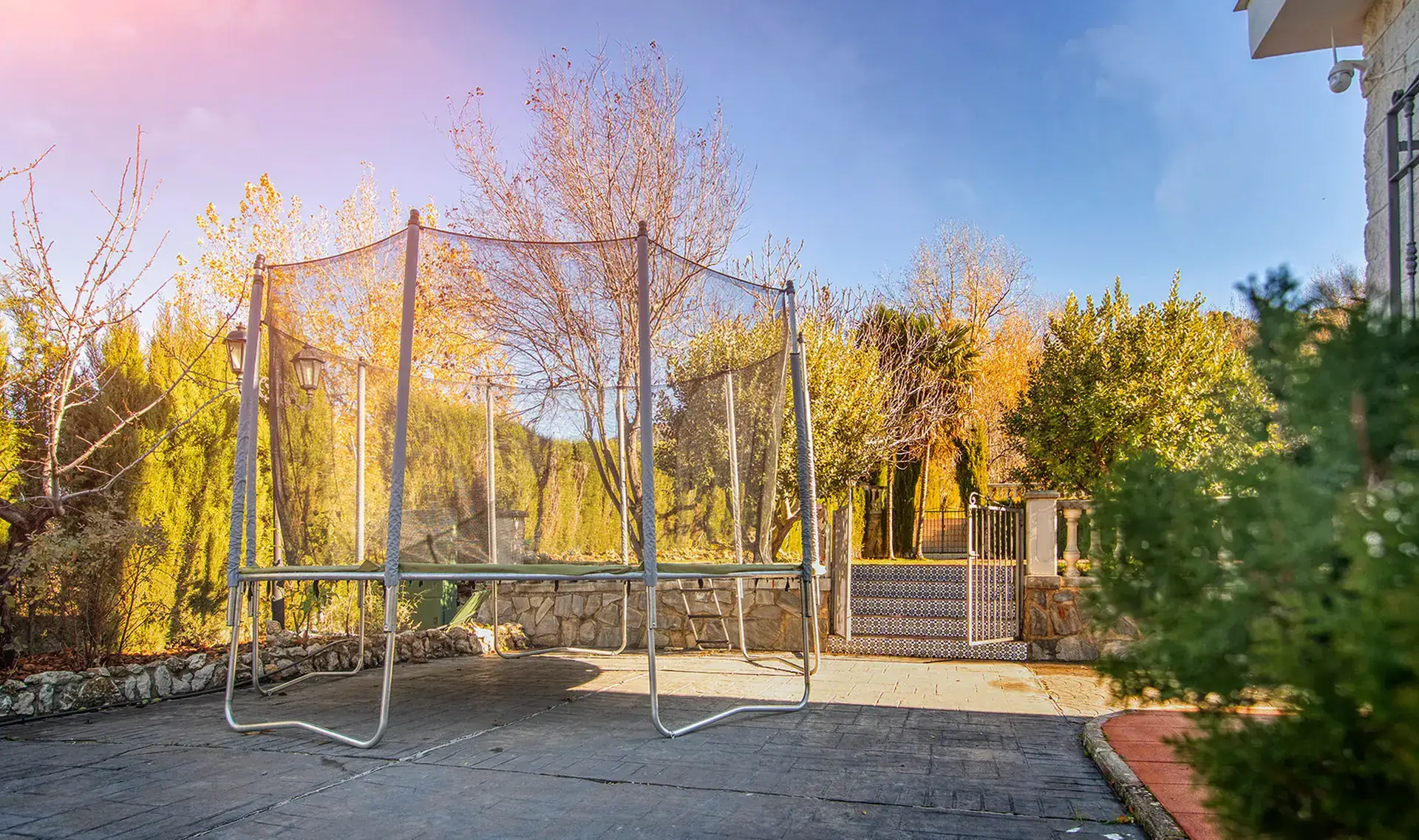 Cama elástica en el jardín, luz de otoño